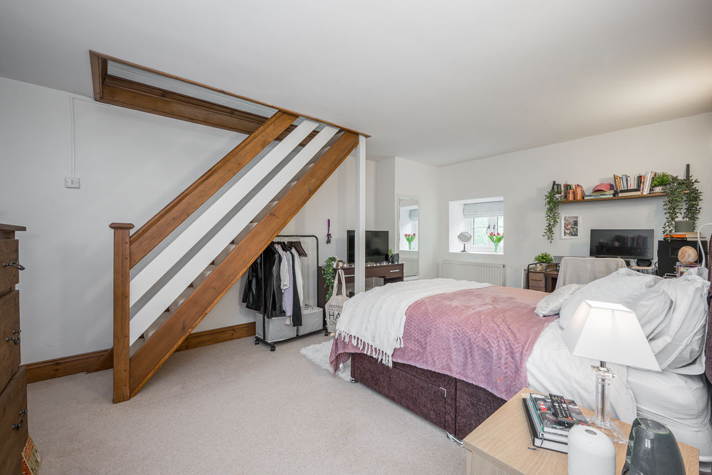 Bedroom with staircase to loft room- click for photo gallery
